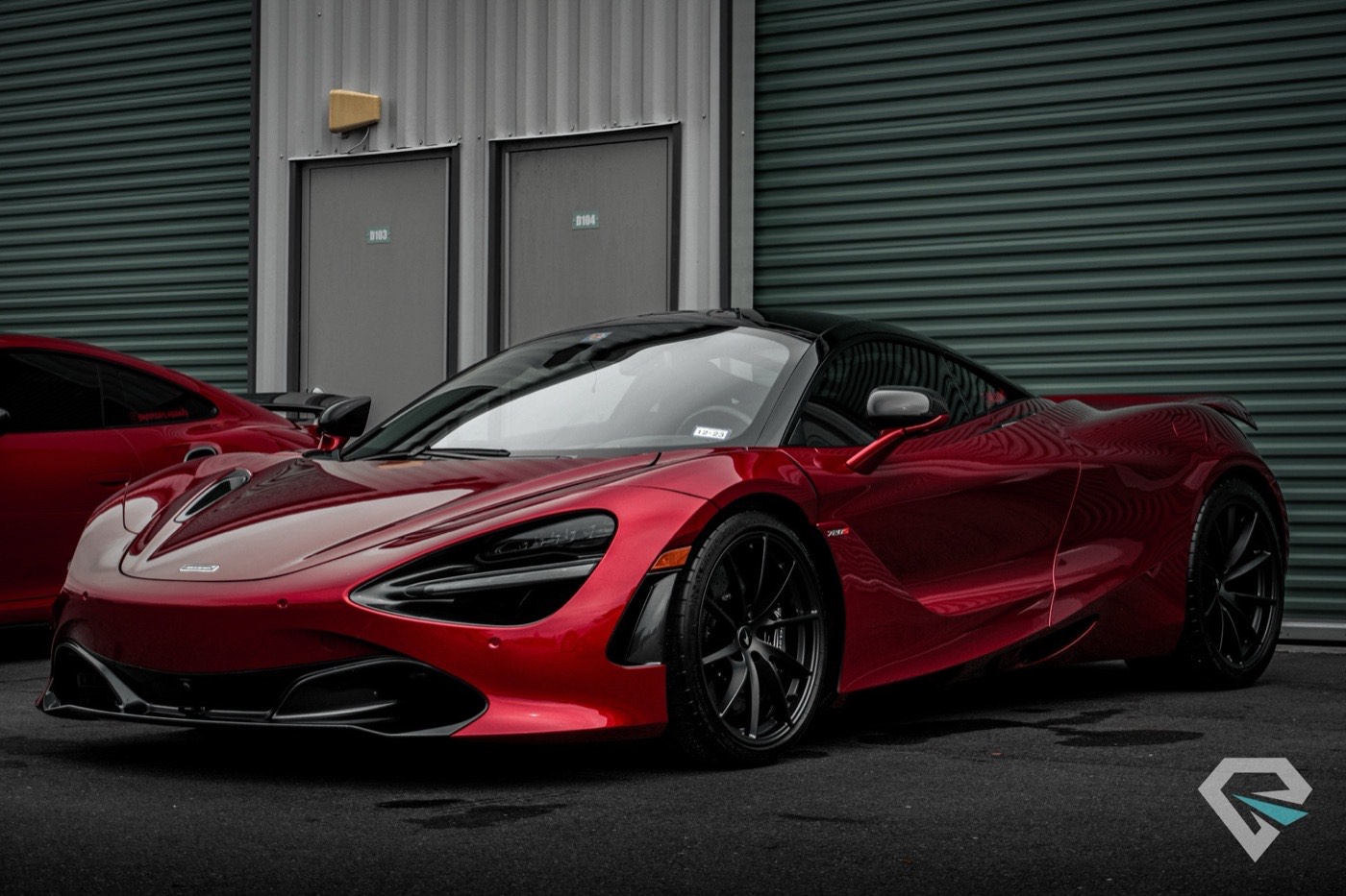 Red McLaren 720S three-quarter view under studio lights