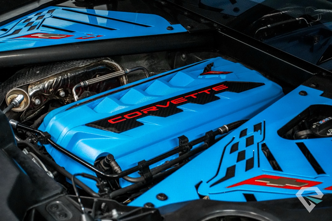 Blue Corvette engine cover under the rear glass