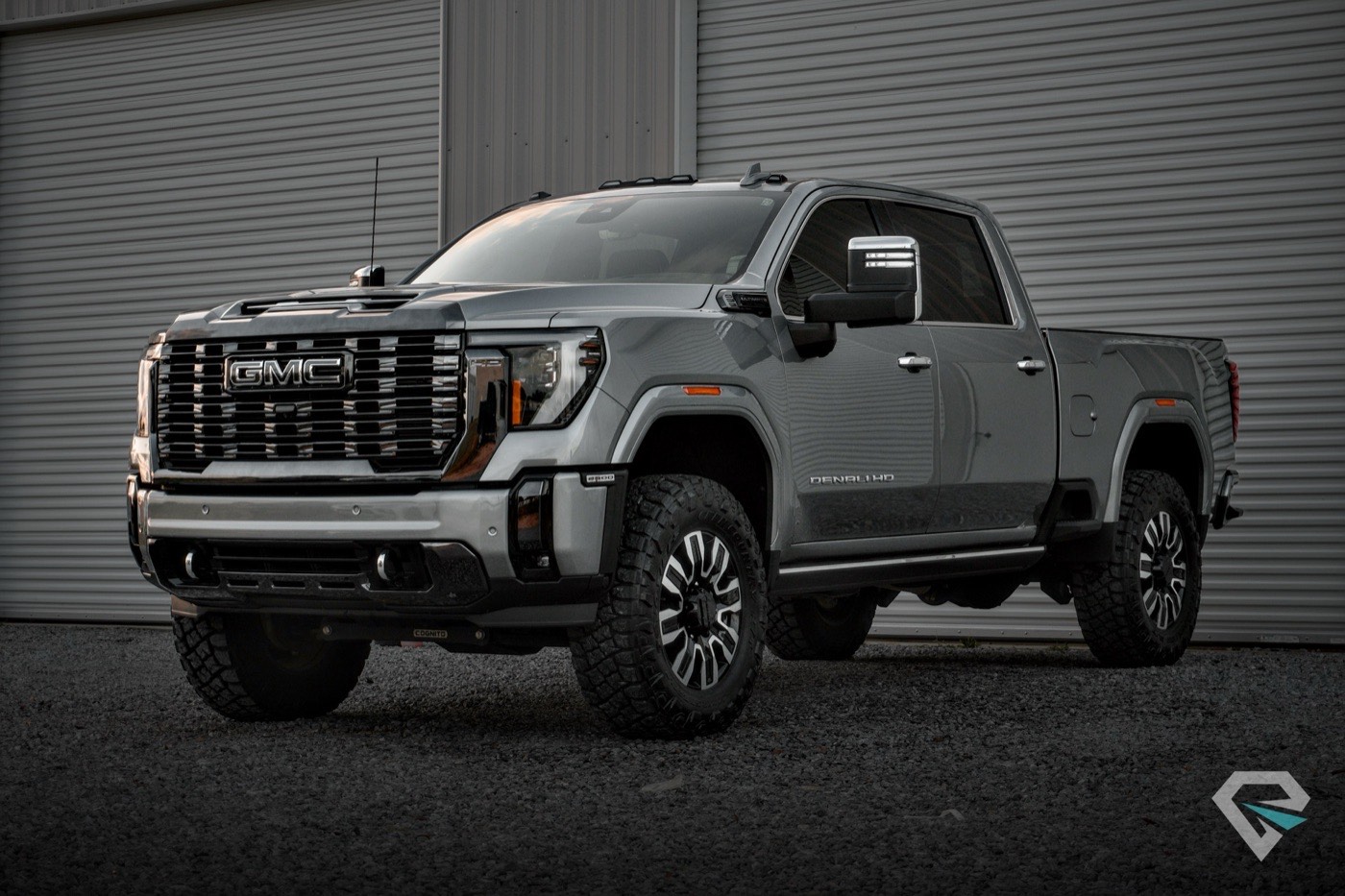 Gray GMC Sierra Denali HD in front of a metal building